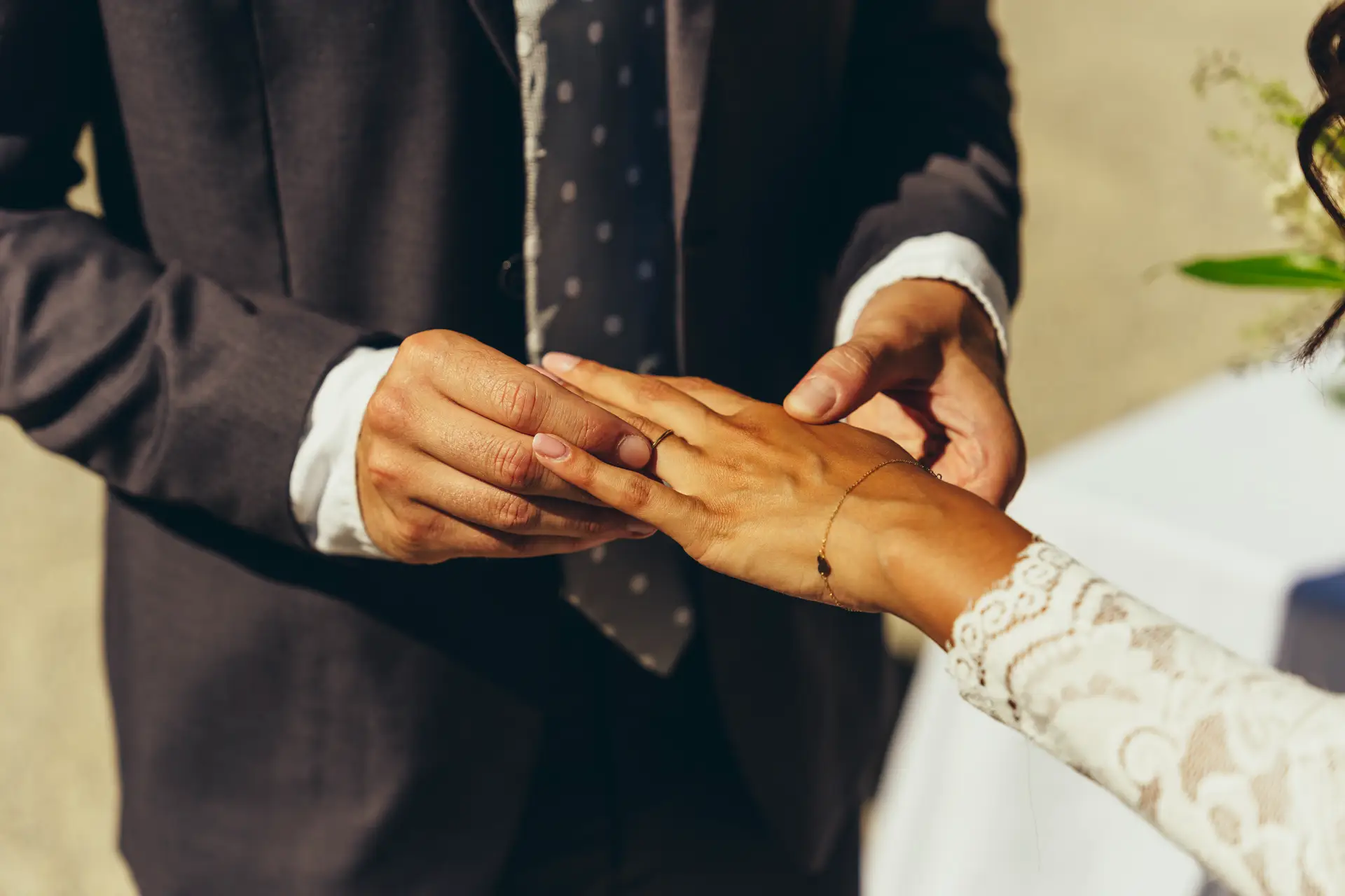 Groom placing the wedding ring on the bride's finger