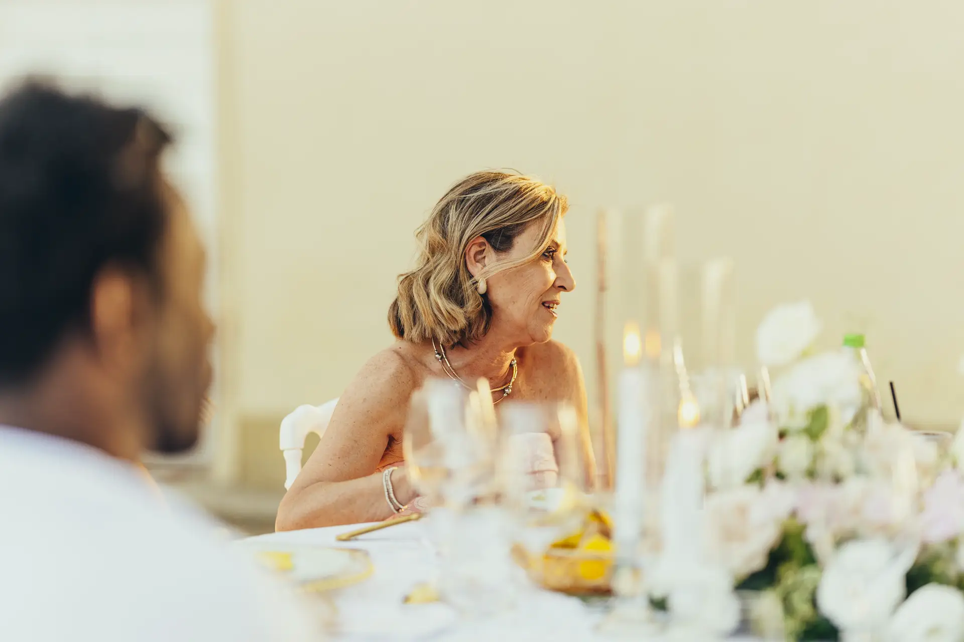 Woman seated at a table at a wedding