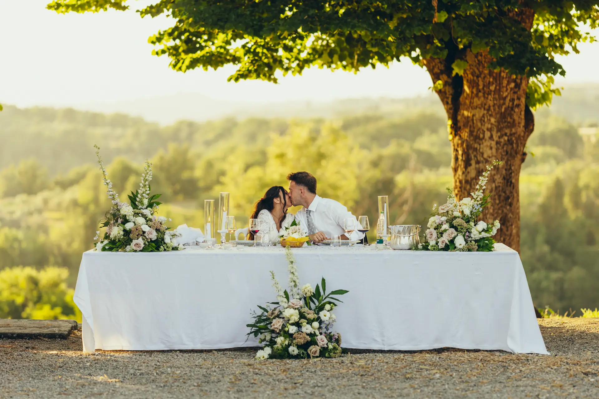 Bride and groom kissing at the table