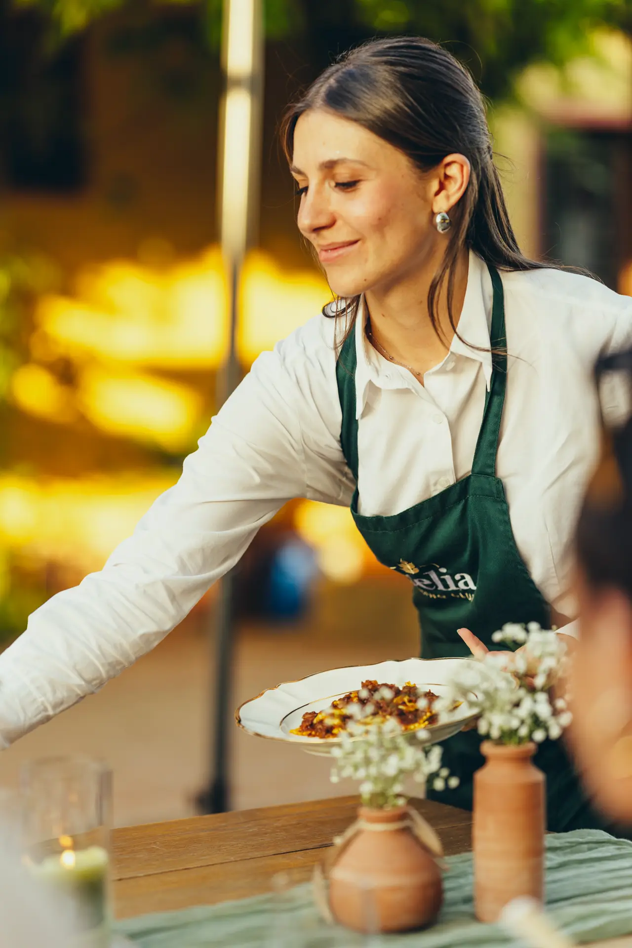 Waitress bringing a plate to the table