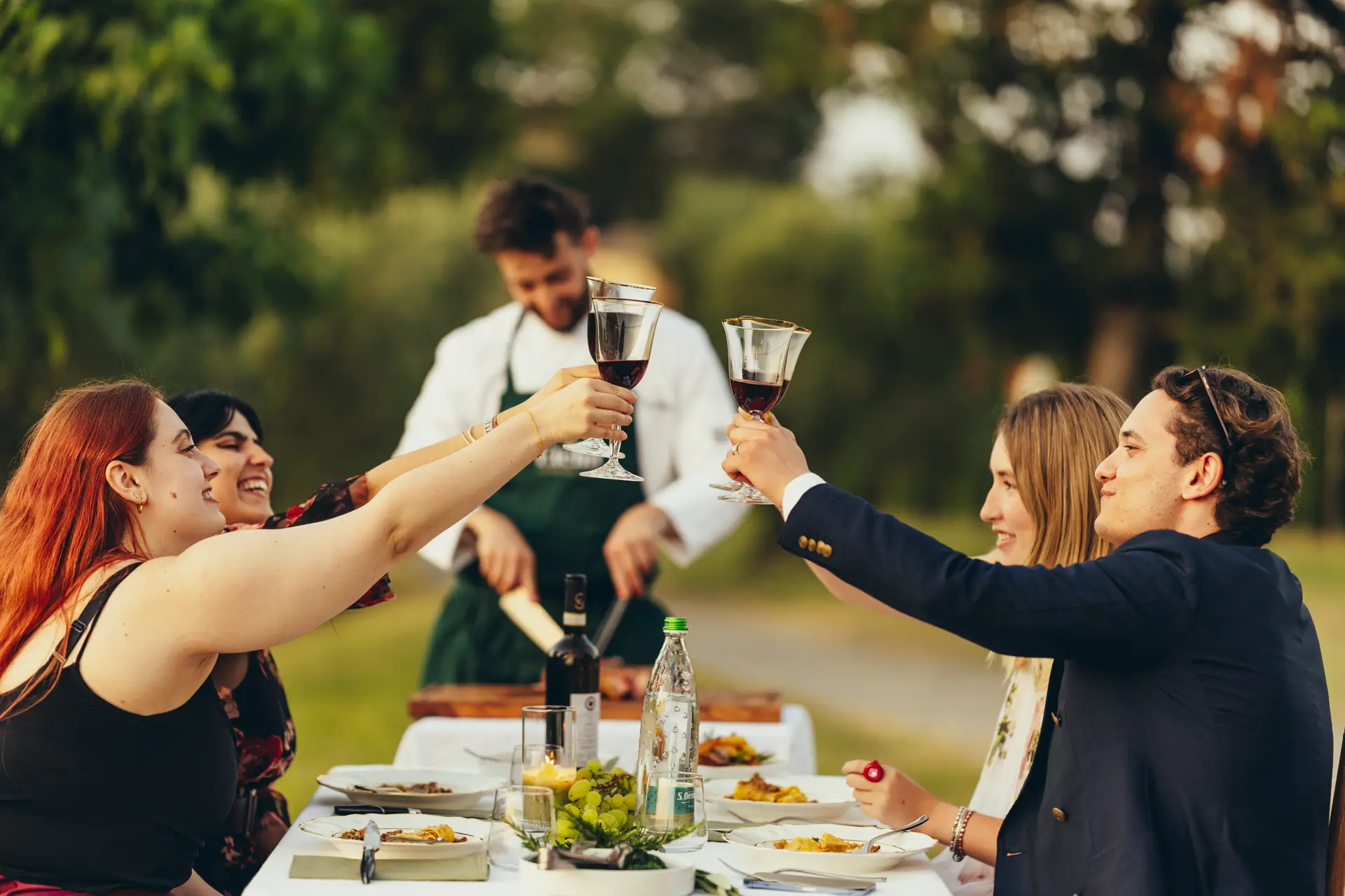 People raising a toast with wine glasses